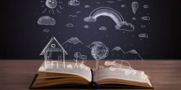Open book with hand drawn landscape on wooden deck